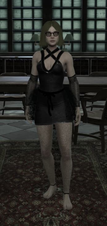 A blonde woman in a black Gothic-style outfit stands in a dimly lit room with large windows. She wears glasses, a corset-like top, fishnet stockings, and lace gloves. The room has a patterned carpet and appears to be in an old building.