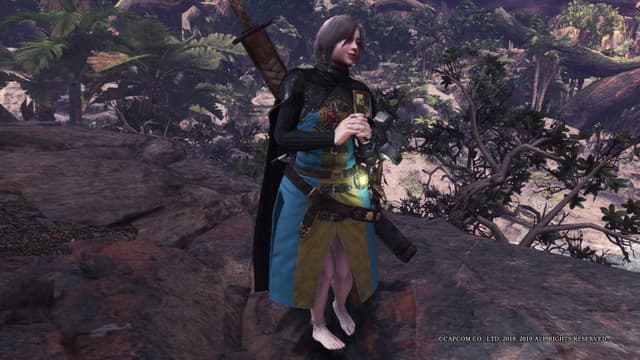 a female character in a fantasy or adventure game setting. She is wearing a dark outfit with ornate details, including a hooded cape and armor-like elements. The character is standing in a lush, jungle-like environment, with tall trees and foliage in the background. She is holding a large weapon, likely a sword or staff, in her hand, suggesting she is a warrior or adventurer. The character has a serious expression on her face, indicating she is focused and ready for action. Overall, the image conveys a sense of mystery, power, and exploration in a fantastical and immersive world.